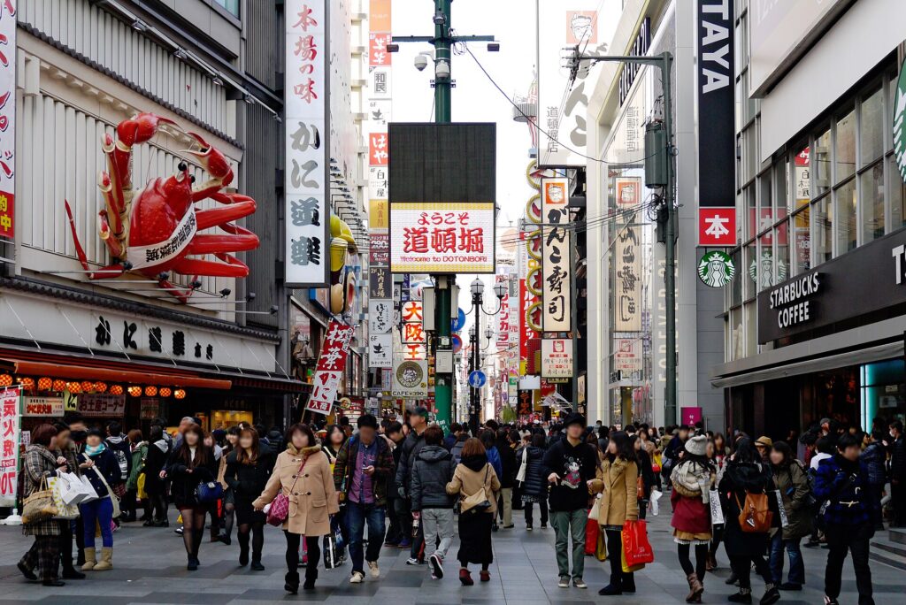 Neon signs and crowds along the Dotonbori canal in Osaka
