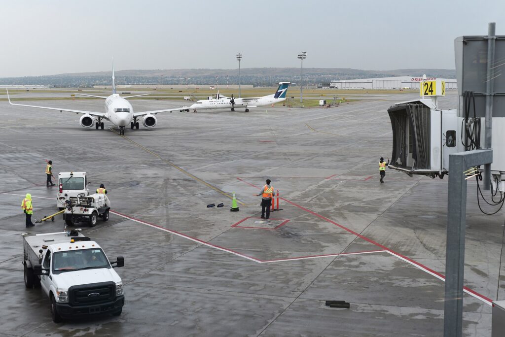 A WestJet Boeing 737 parked at a gate at Calgary International Airport