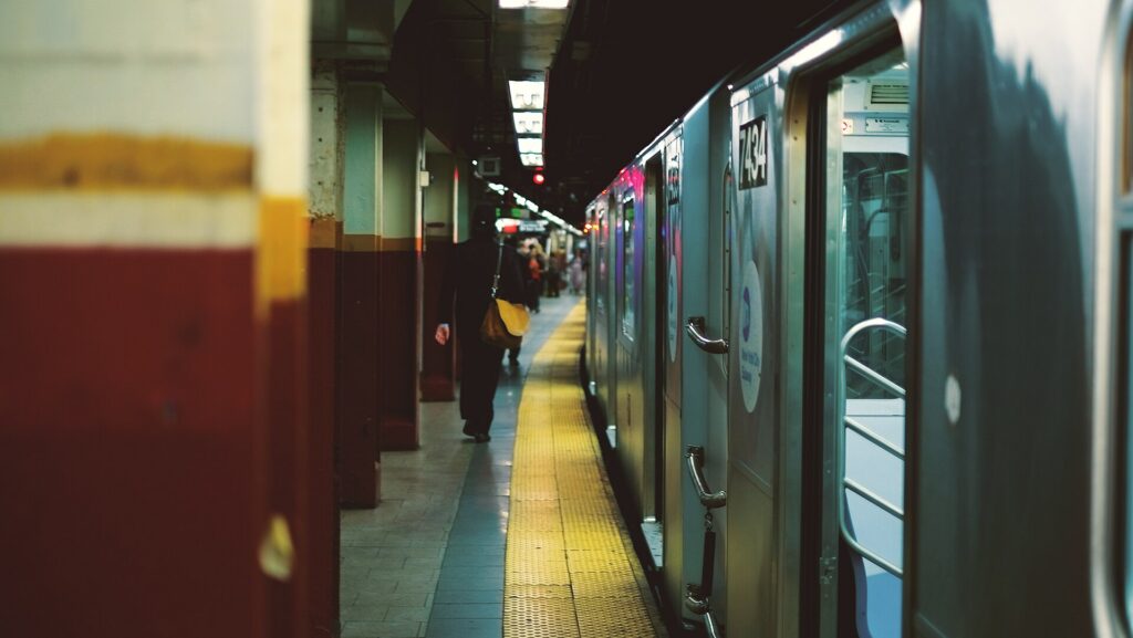 A subway train pulling into a station platform in New York City