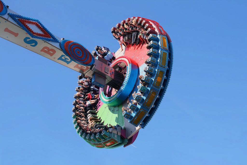 Fairground rides and show booths lit up at Oktoberfest in Munich