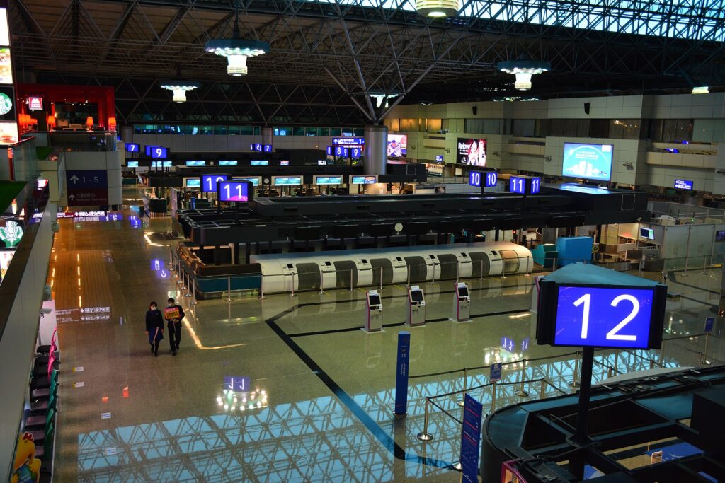Rows of airline check-in counters in an international departure hall
