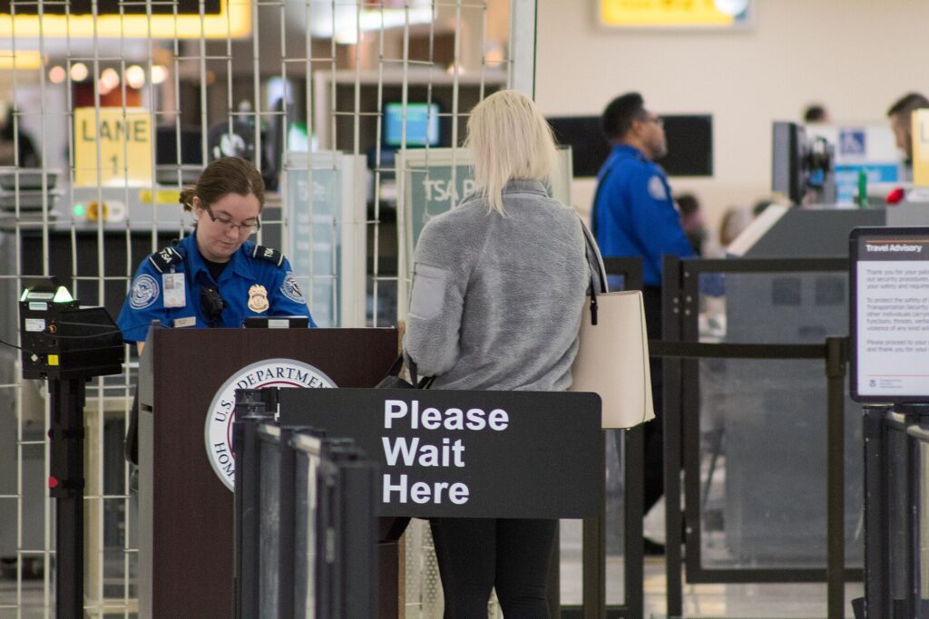 A security officer at an airport screening checkpoint