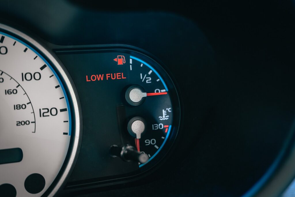 A car fuel gauge reading close to empty
