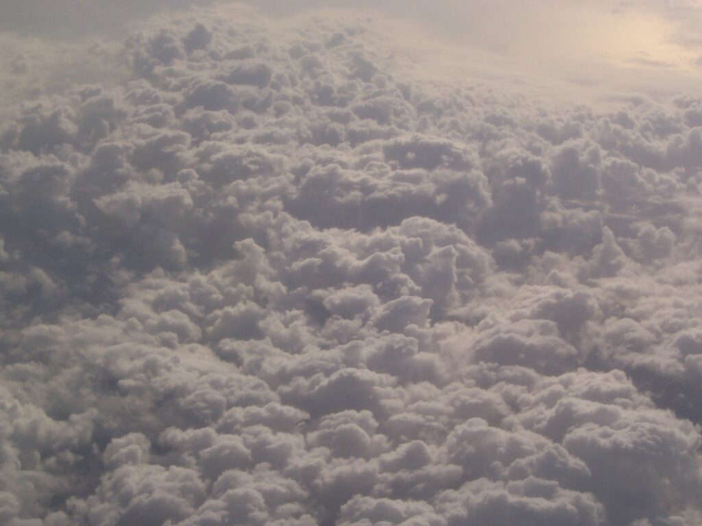 A view of clouds from the window seat of an airplane