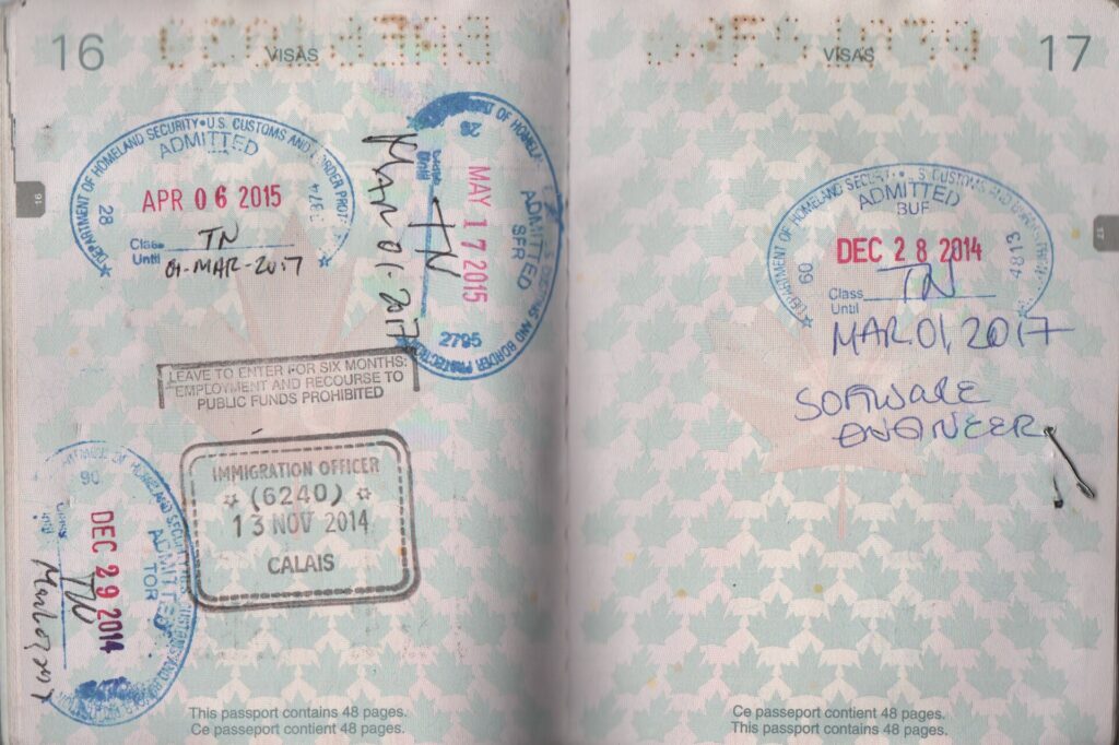 Open passport pages with entry stamps from the United States and United Kingdom