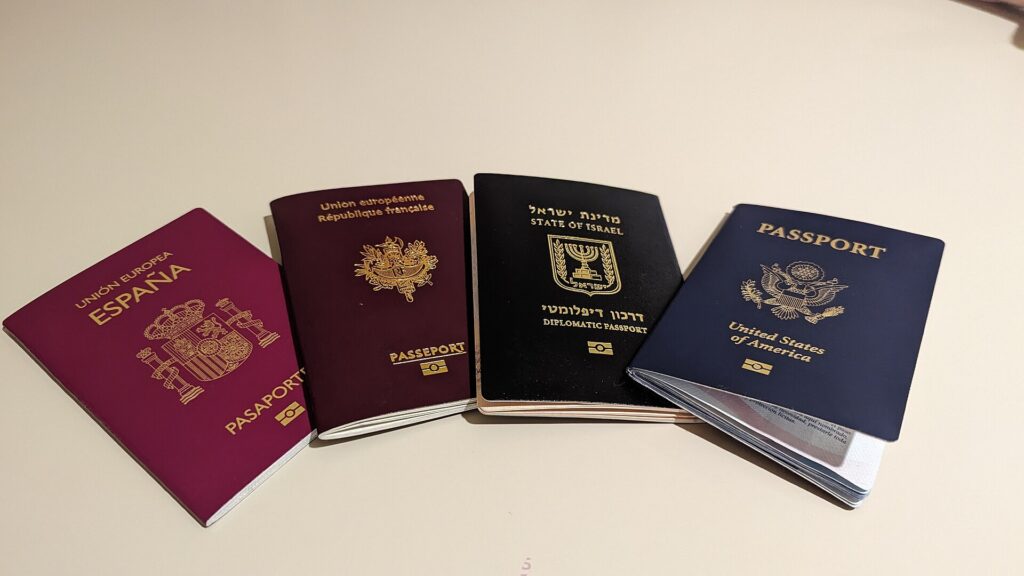 Four different national passports laid side by side