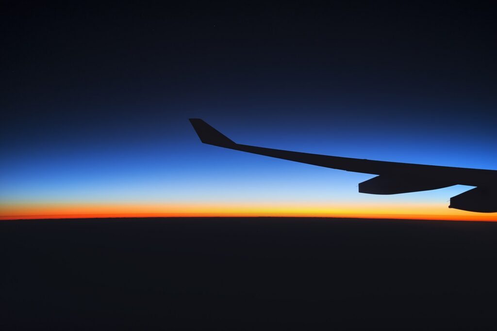 Sunrise seen through an airplane window above the clouds