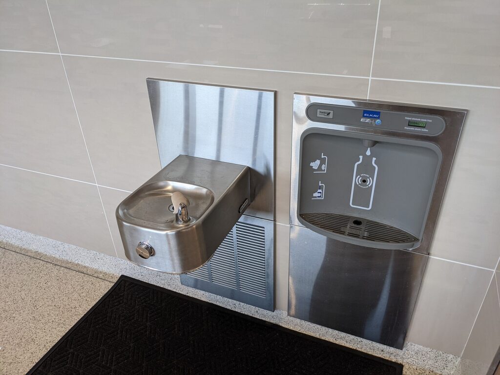 A drinking water fountain and bottle filling station in an airport terminal