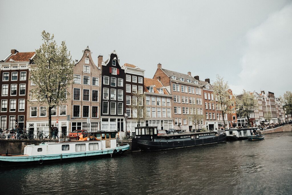 Gabled canal houses along a quiet canal in Amsterdam