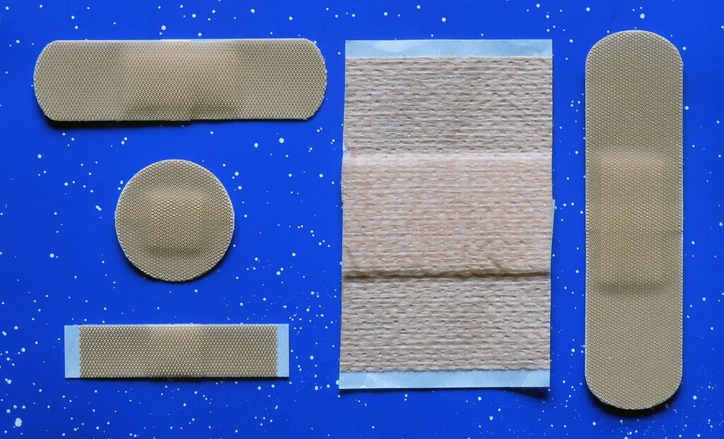 Adhesive bandages in several sizes, including a large elastic one