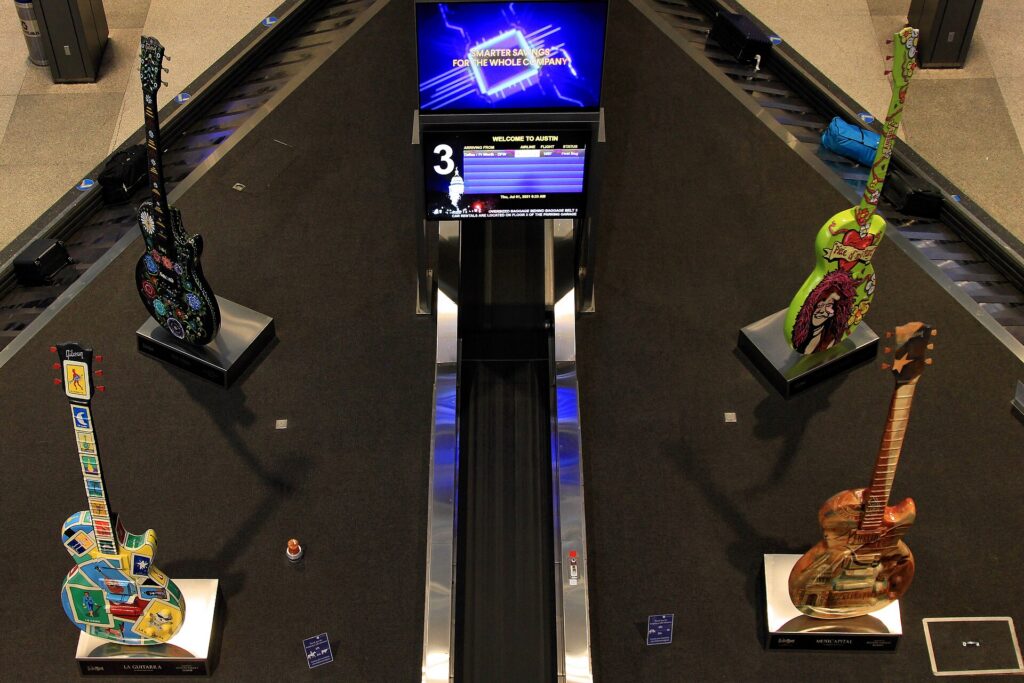 An airport baggage claim carousel in an arrivals hall