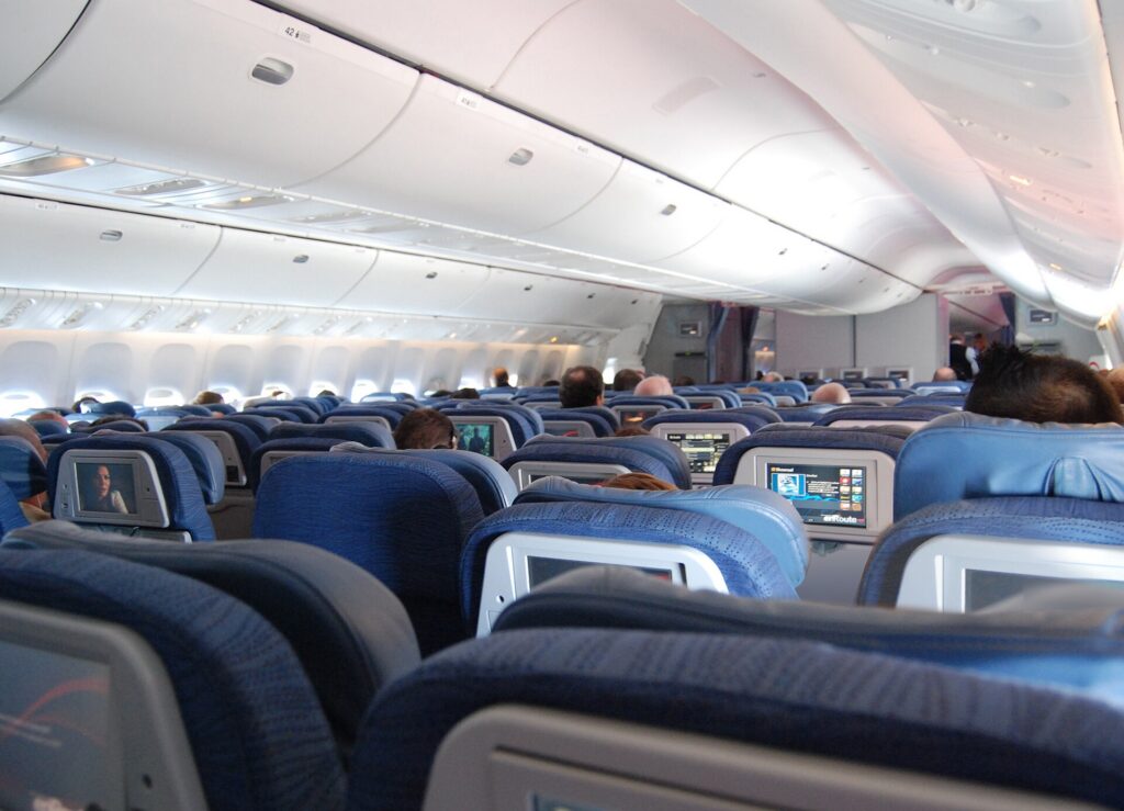Rows of economy seats in the cabin of an Air Canada Boeing 777