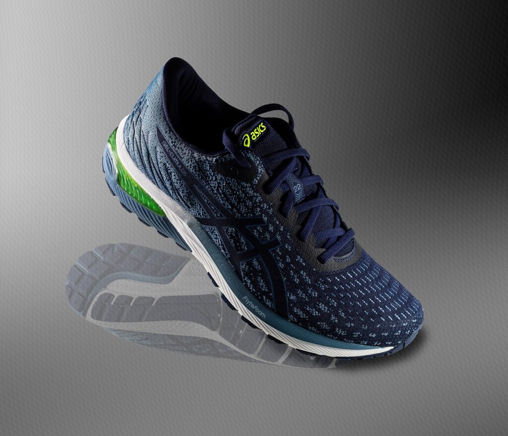 A pair of cushioned running shoes photographed against a plain background