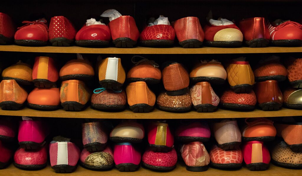 Rows of shoes on display in a shoe store