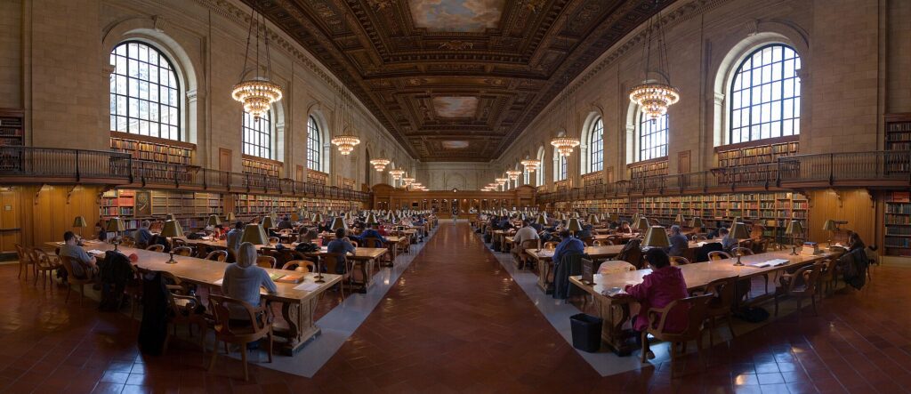 Long wooden reading tables in a research room at the New York Public Library