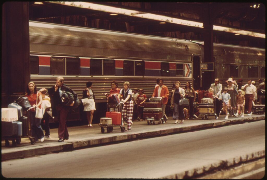 Vintage photo of passengers with luggage walking along a platform beside a train at Chicago Union Station