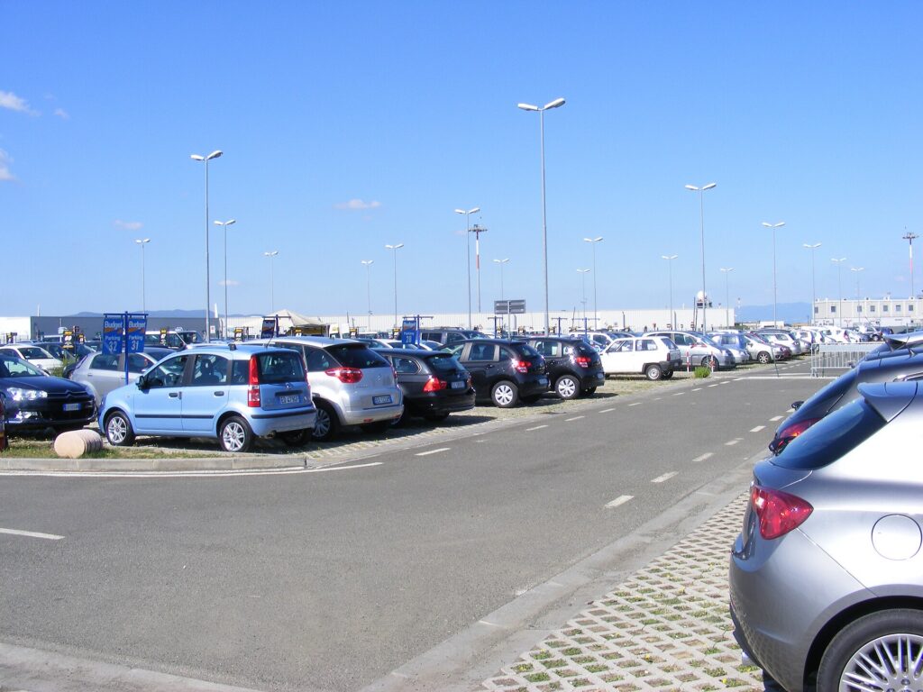 Rows of rental cars parked in an airport rental lot