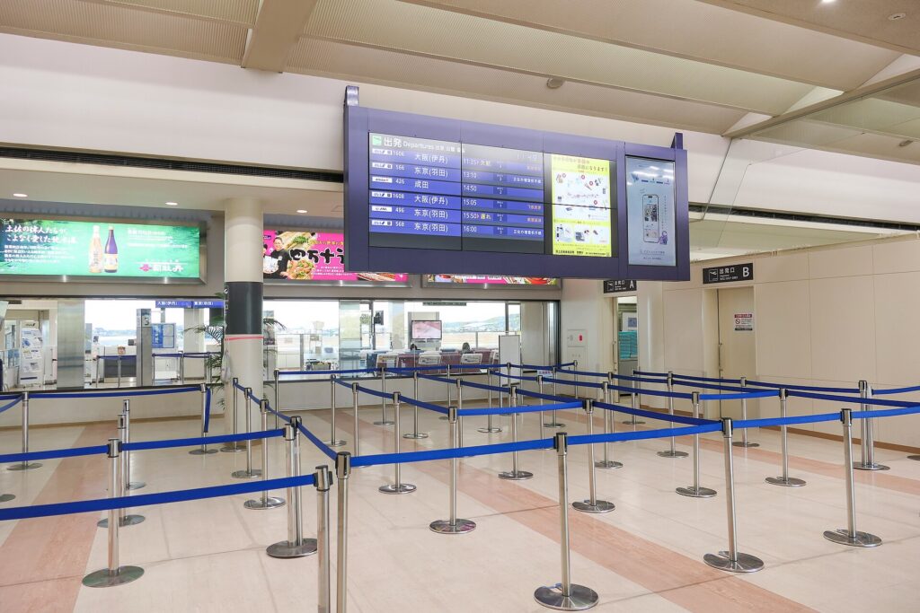 An airport security checkpoint with queue barriers and screening lanes