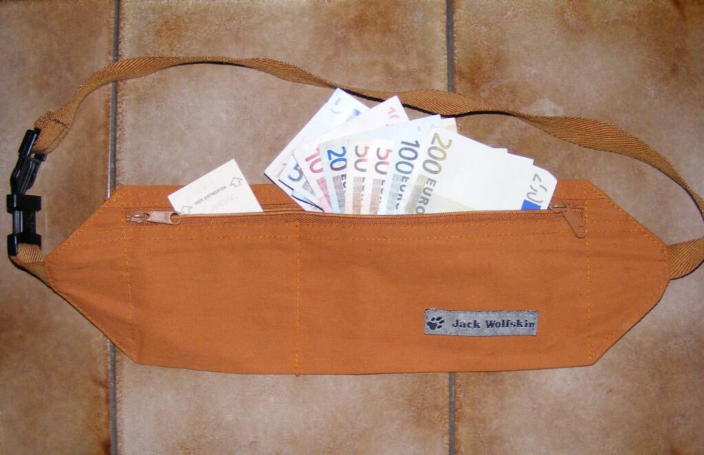 A brown belt with a hidden zippered compartment for folded cash