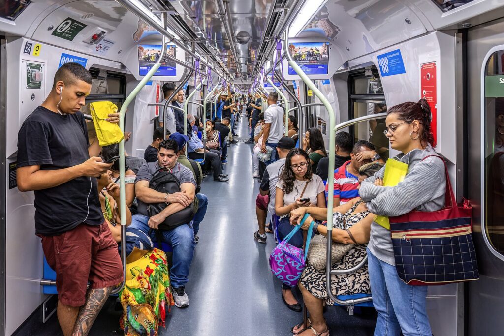 Passengers standing close together in a crowded metro carriage