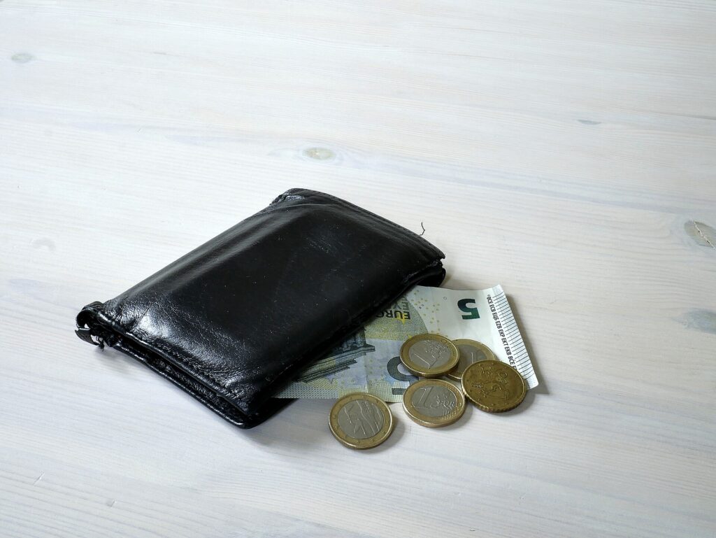 A wallet with banknotes and coins