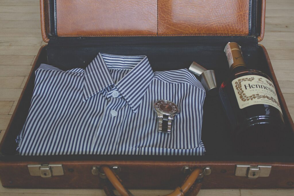 Clothes and travel essentials being packed into an open suitcase