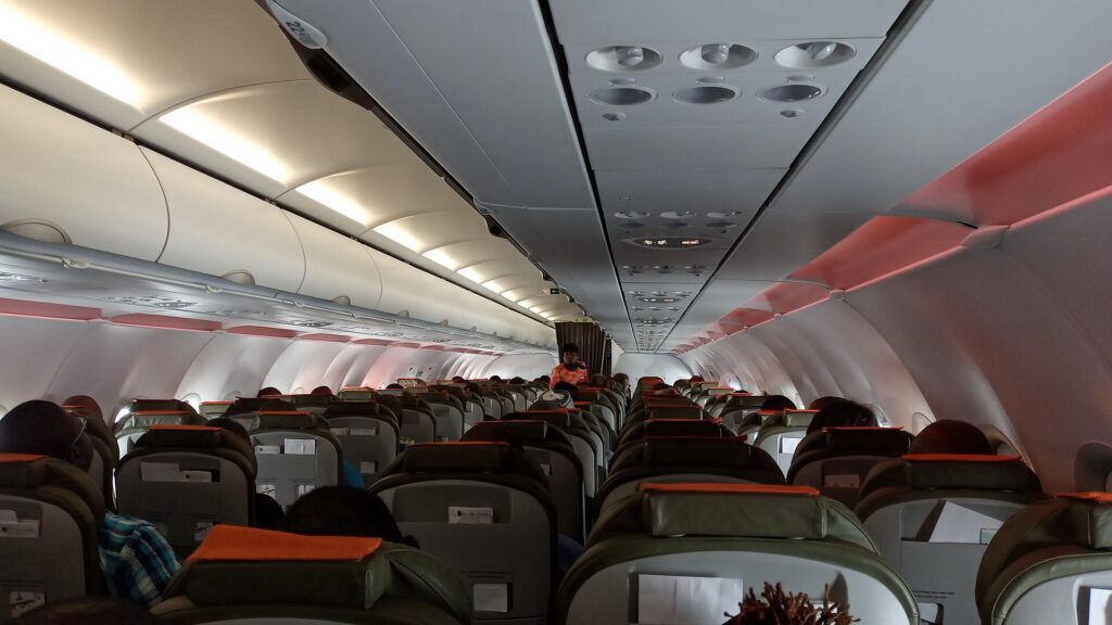 Passengers seated in the economy cabin of an airliner