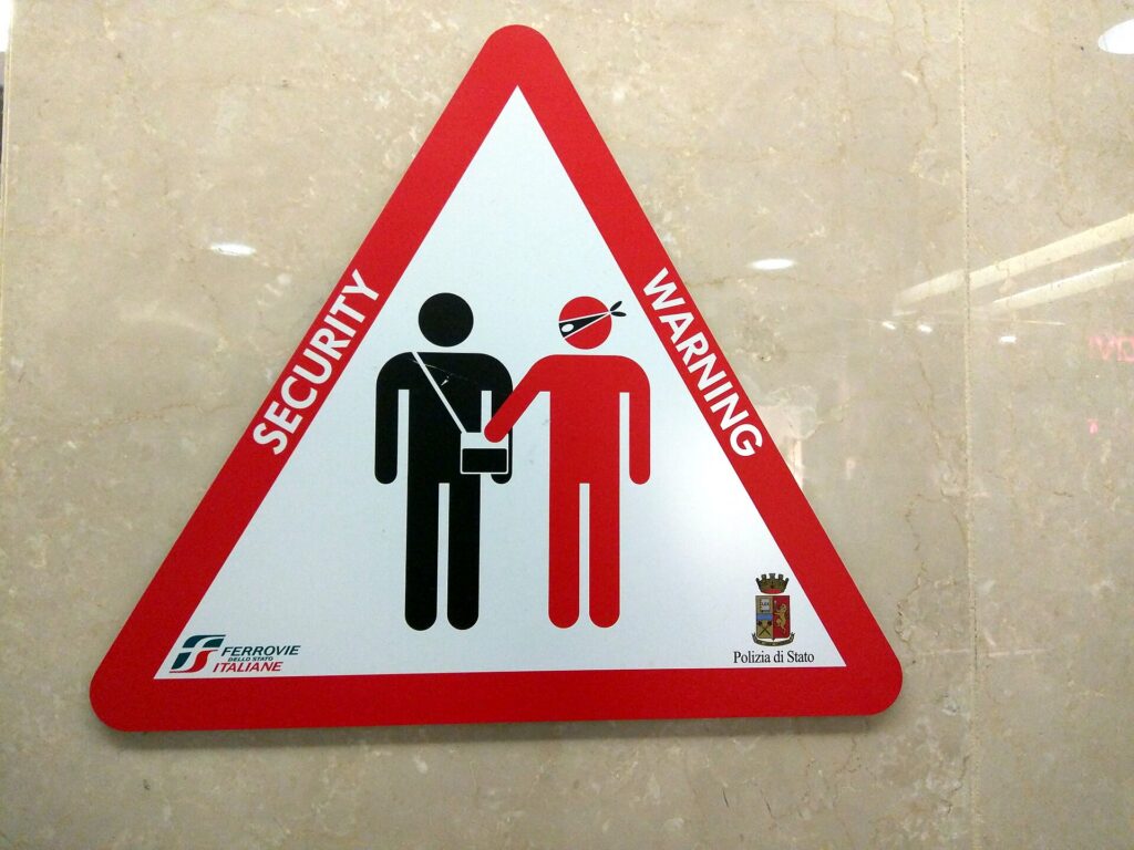 A pickpocket warning sign in a railway station