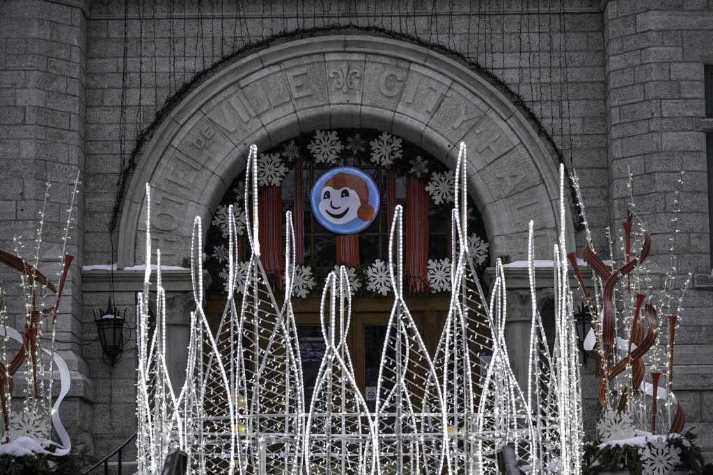 A Bonhomme Carnaval decoration on a stone archway in Old Quebec during the Winter Carnival