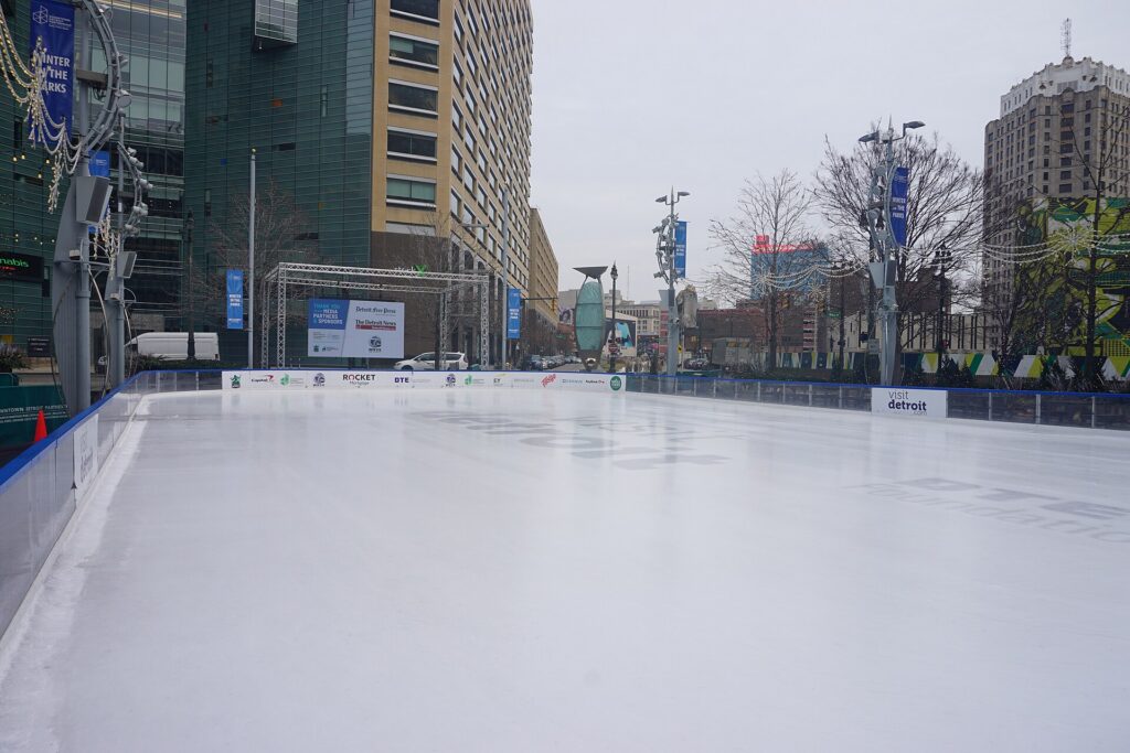 Skaters on the ice rink at Campus Martius Park in downtown Detroit in winter