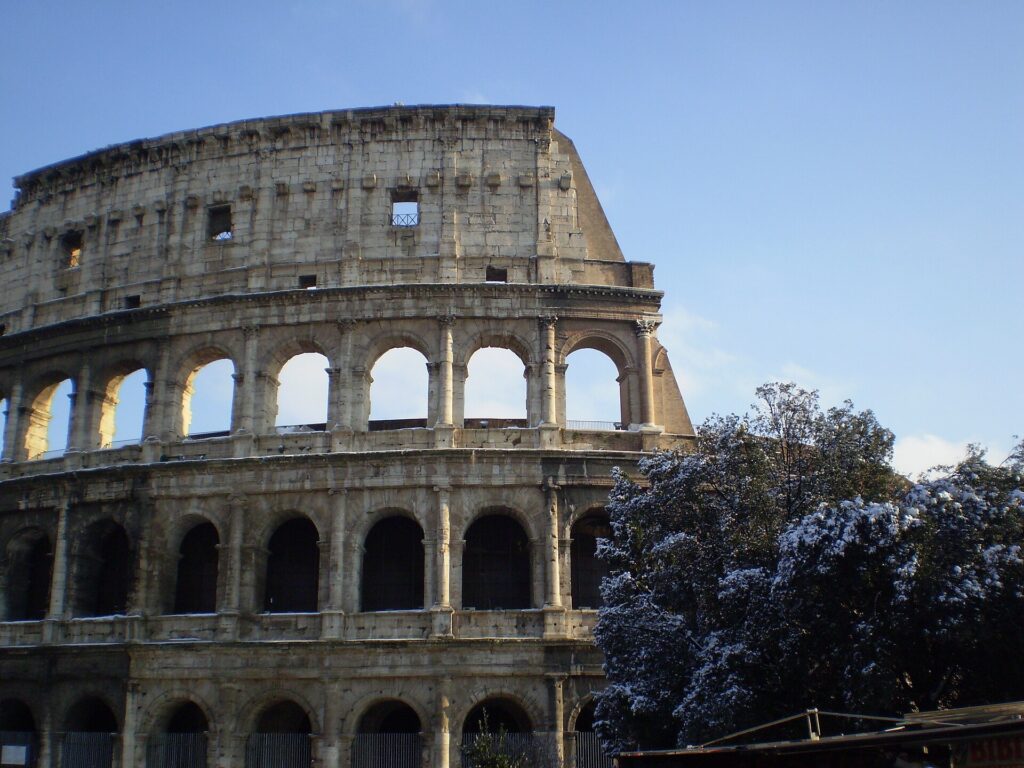 The Colosseum in Rome with a light covering of snow