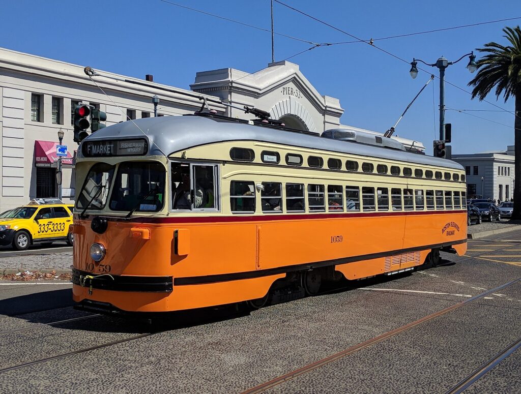 A historic F-line streetcar running along the Embarcadero in San Francisco