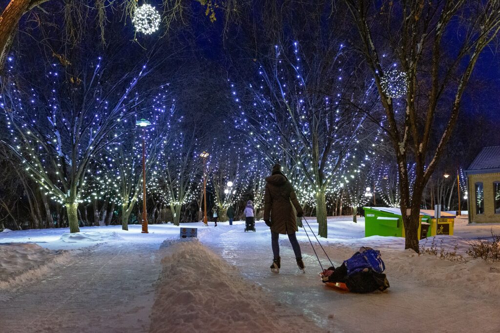 Skaters crossing the rail bridge on the river trail at The Forks in Winnipeg