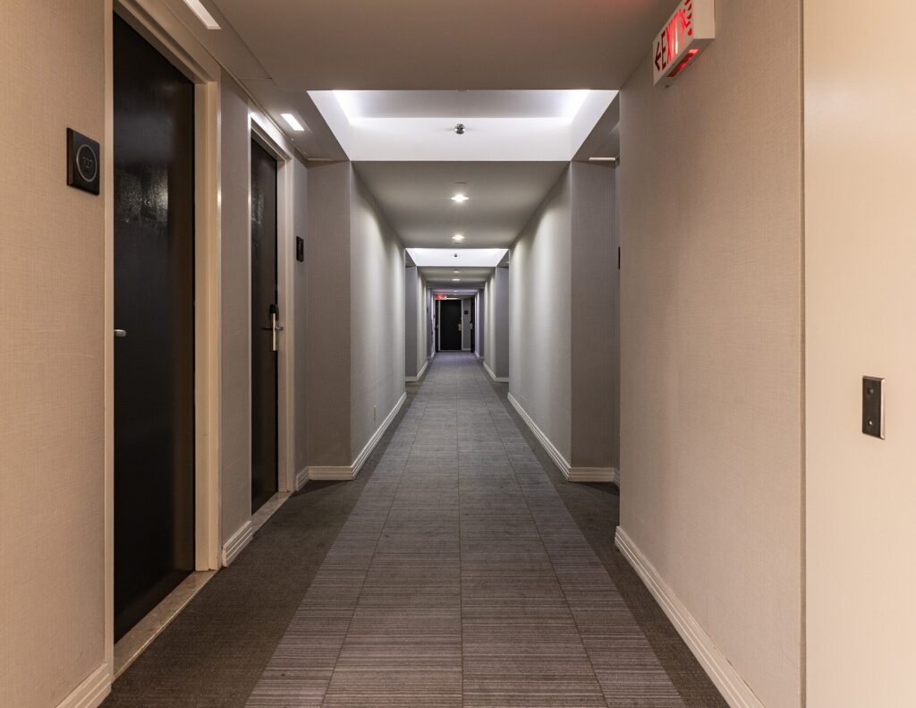 A carpeted guest-room corridor in a downtown Toronto hotel