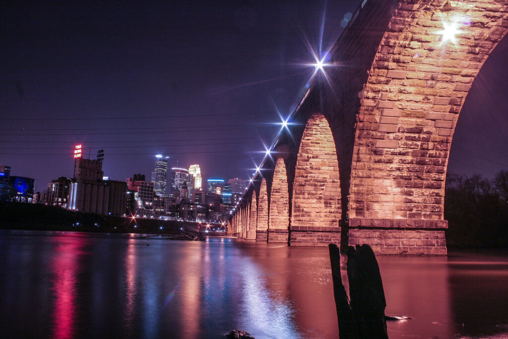 The Stone Arch Bridge and the downtown Minneapolis skyline above the Mississippi River