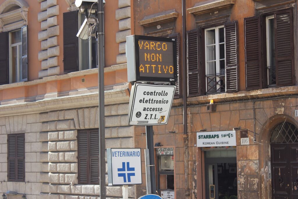 A limited-traffic zone gate with camera and sign on Via Cavour in Rome