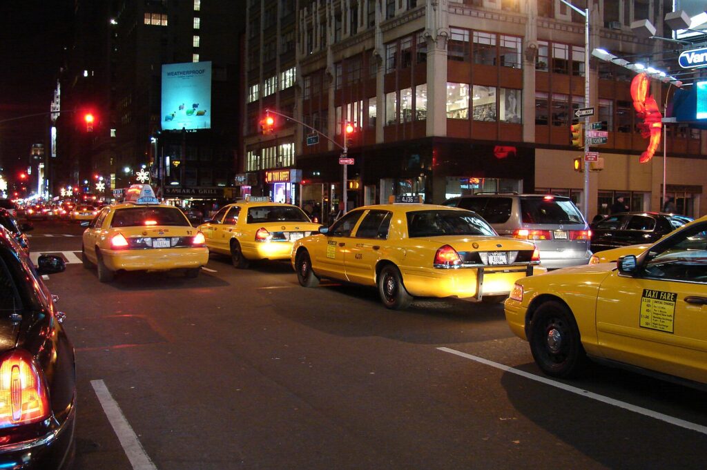 Yellow taxis on a Manhattan street at night